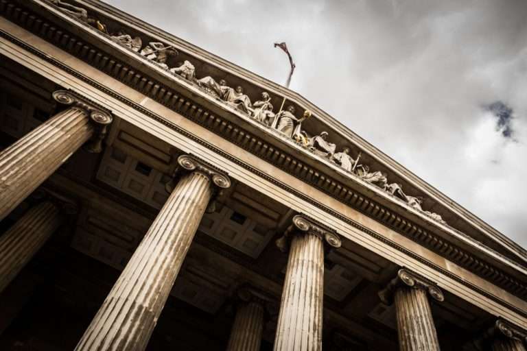 darkened picture of a courthouse and a cloudy sky