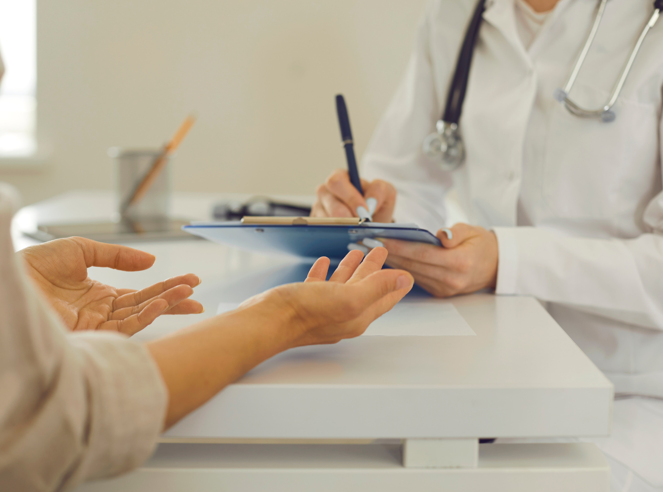 doctor taking notes from a person talking