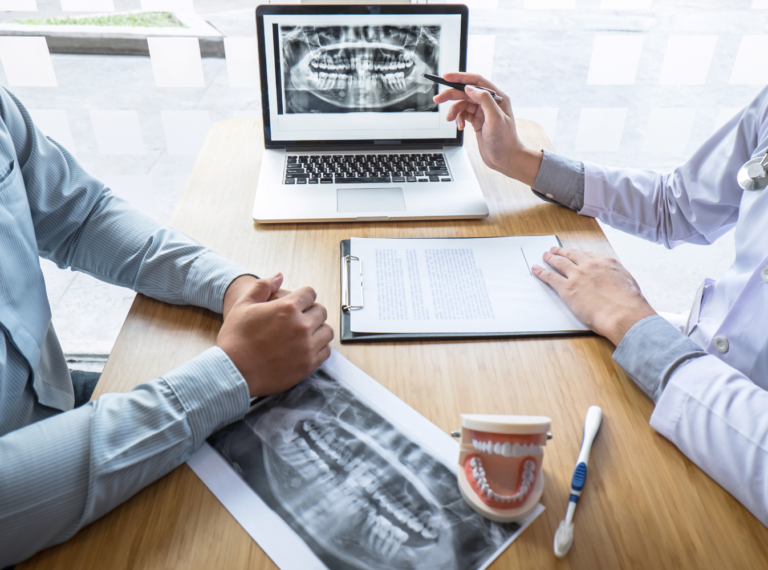 people reviewing scans of a jaw