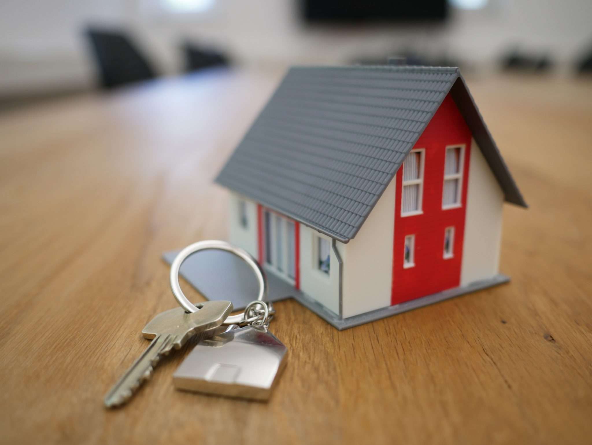 key chain with keys and a small house next to it
