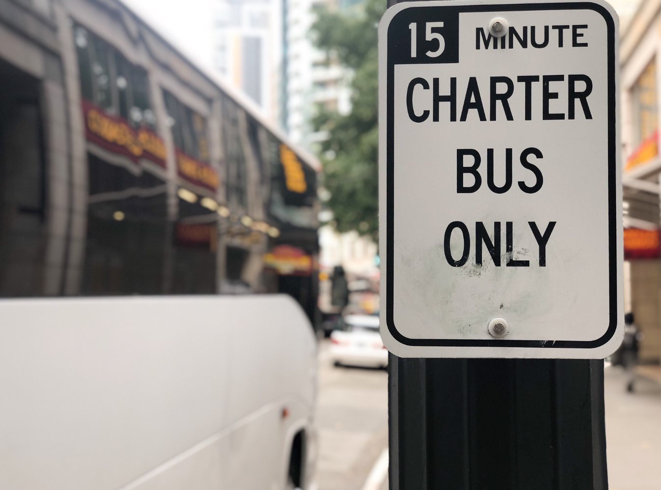 charter bus parking sign with charter bus nearby