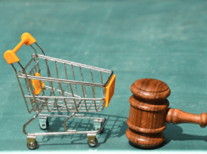 small shopping cart to a wooden gavel