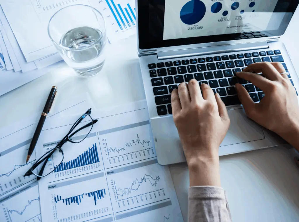 person on computer with graphs and charts