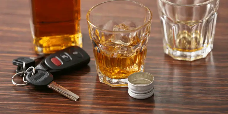 keys next to a bottle and glass