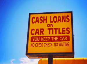 picture of a sign that reads "cash loands on car titles you keep the car no credit check no waiting"