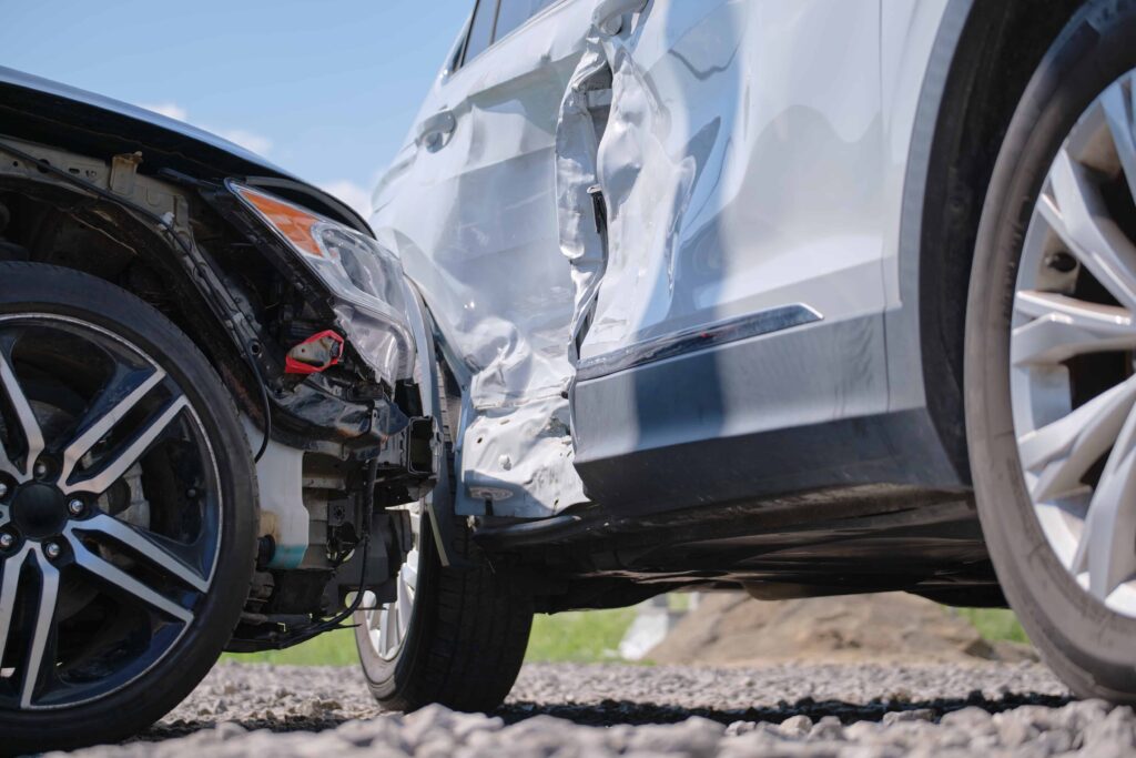 Close-up of two cars with severe collision damage after a side-impact crash.