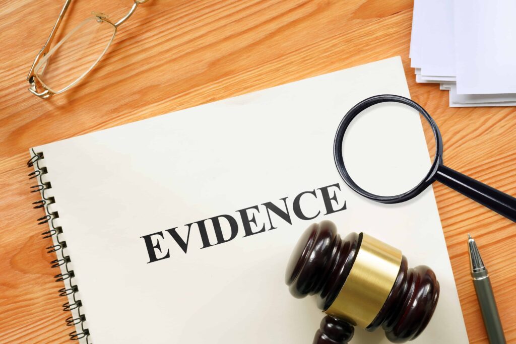 Legal evidence folder with gavel and magnifying glass on desk