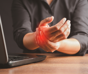 someone holding their wrist indicating pain