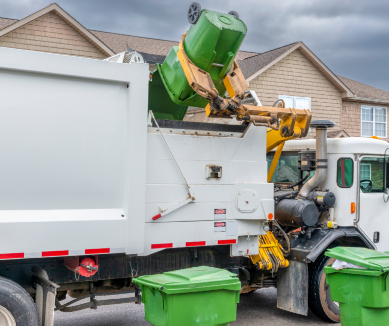 garbage truck unloading cans